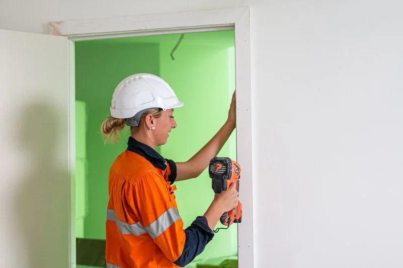 builder working on a doorframe