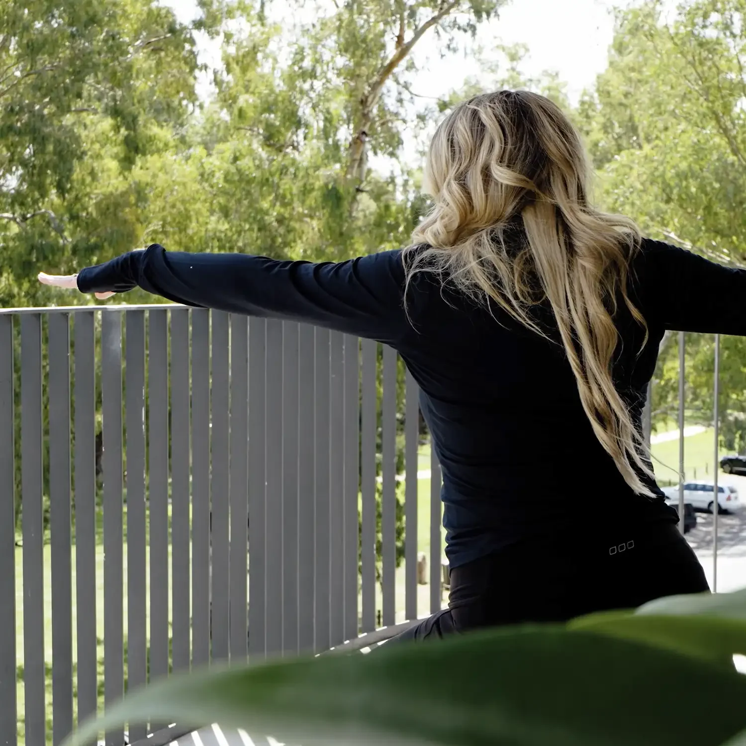 lady doing yoga on an apartment balcony