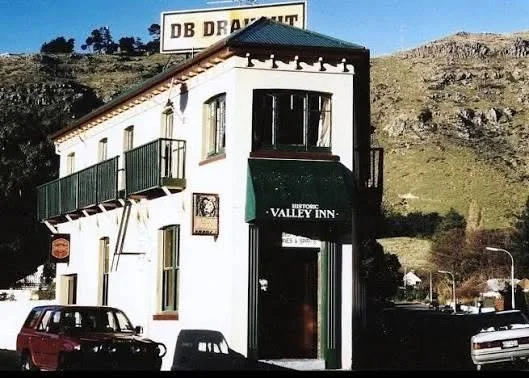 Historic Valley Inn building with a DB Brewery sign in a rugged hillside mining town