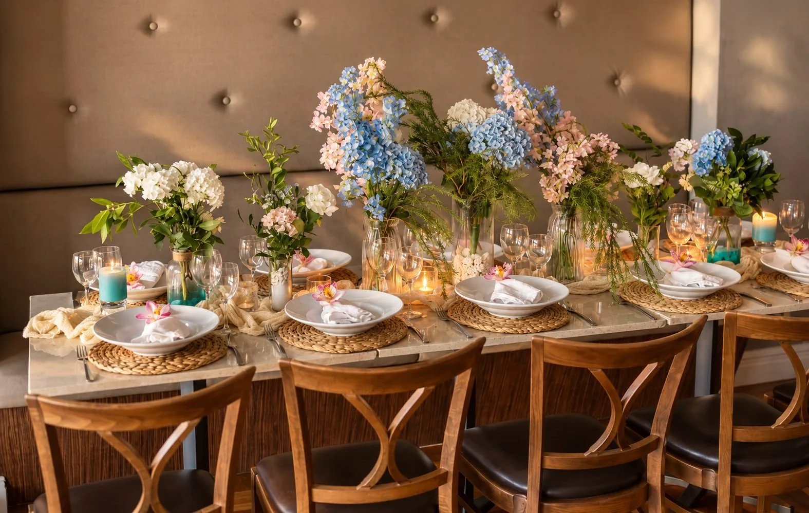 Long table celebration with blue and pink hydrangeas, candles and woven placemats, Gold Coast