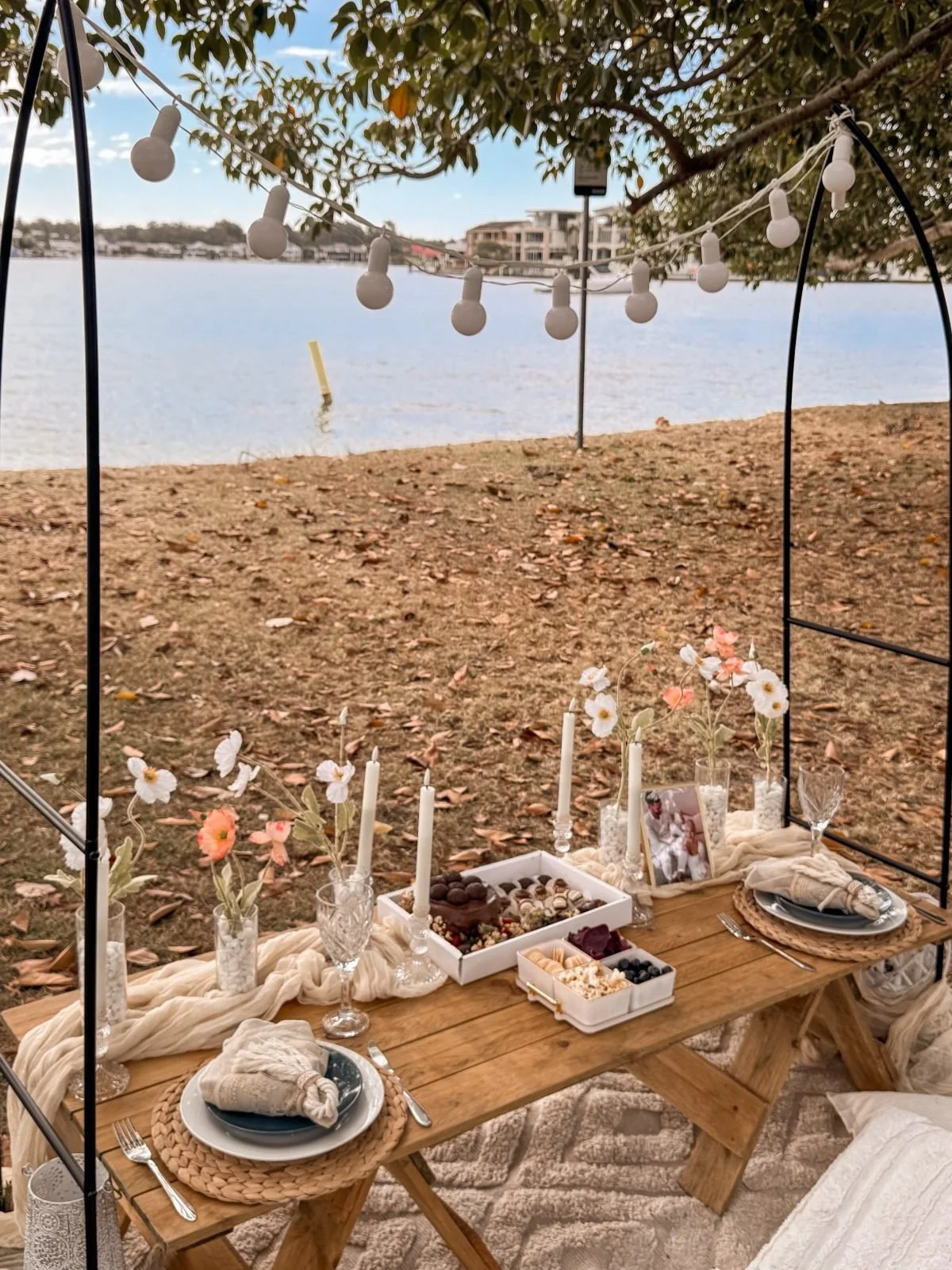 Picnic table under an arch with candles and grazing platters, Gold Coast