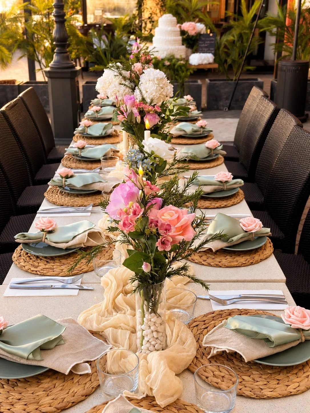 Long table event setting with roses and a white tiered cake at the end, Gold Coast