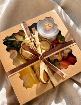 Gift box with juice, fruit and treats tied with a ribbon, Gold Coast