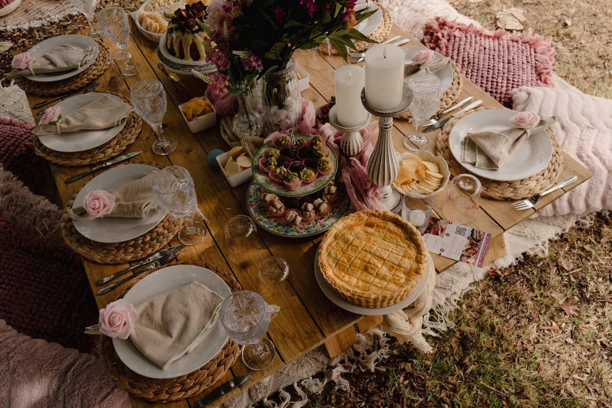 Picnic table spread with savoury pie, desserts and florals, Gold Coast