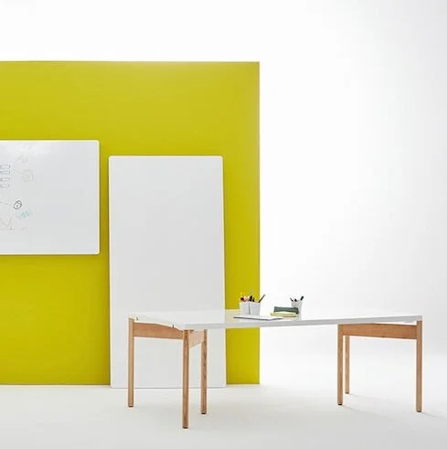 Moving Walls’ lightweight tabletop can double as a presentation whiteboard. Mounted on two solid wood 3-legged trestles, it can also be hung on a Moving Rail system.