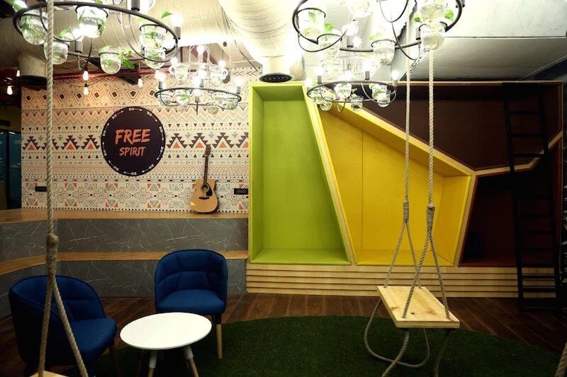 Innov8 in India design beautifully crafted co-working spaces where people can create, connect, and grow their businesses. Traditional interiors are being replaced with bright colours and swings.
