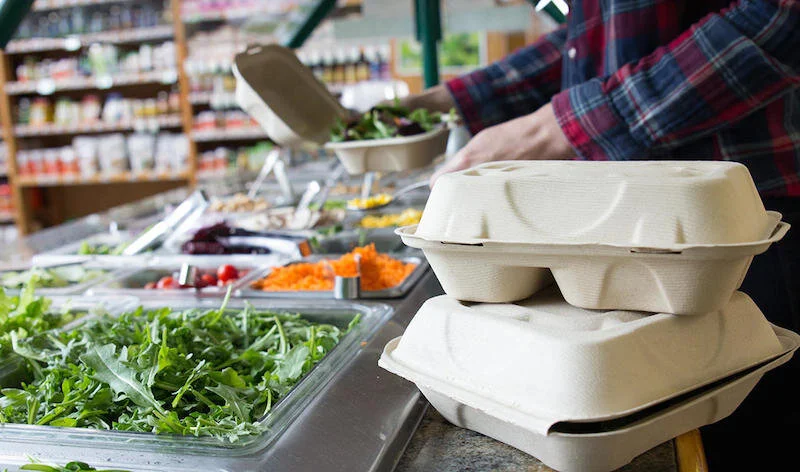 Compostable take away containers by World Centric are made from a variety of materials including compostable PLA plastic derived from cornstarch, wheat straw and sustainable paper alternatives.