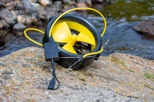 WaterLily is a portable turbine that generates power from rivers. It can charge USB and 12V devices, including cell phones, battery banks, camp lights, and Bluetooth speakers. When used in an average river, it can charge most small electronics as fas