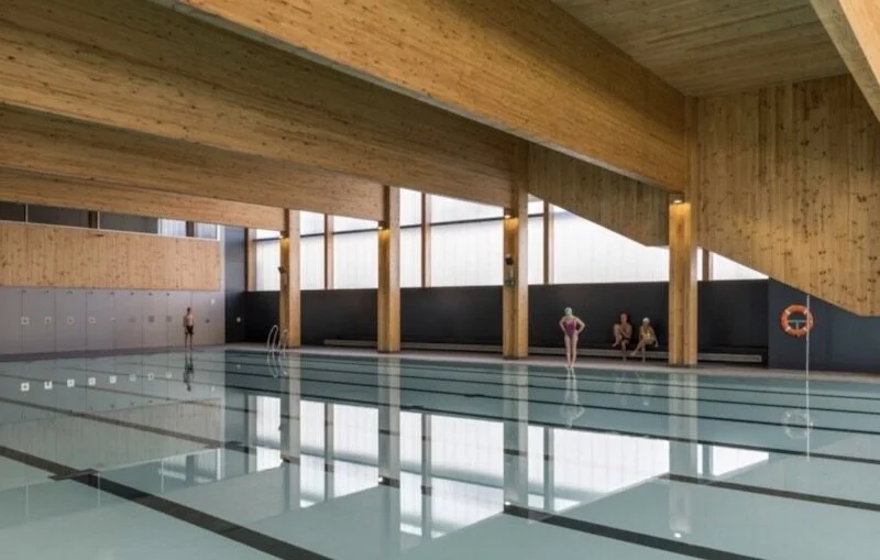The Turó de la Peira Sports Center, constructed out of 2 existing buildings, incorporates a hydroponic green façade with a solar powered rooftop and an aerothermal system that heats hot water.