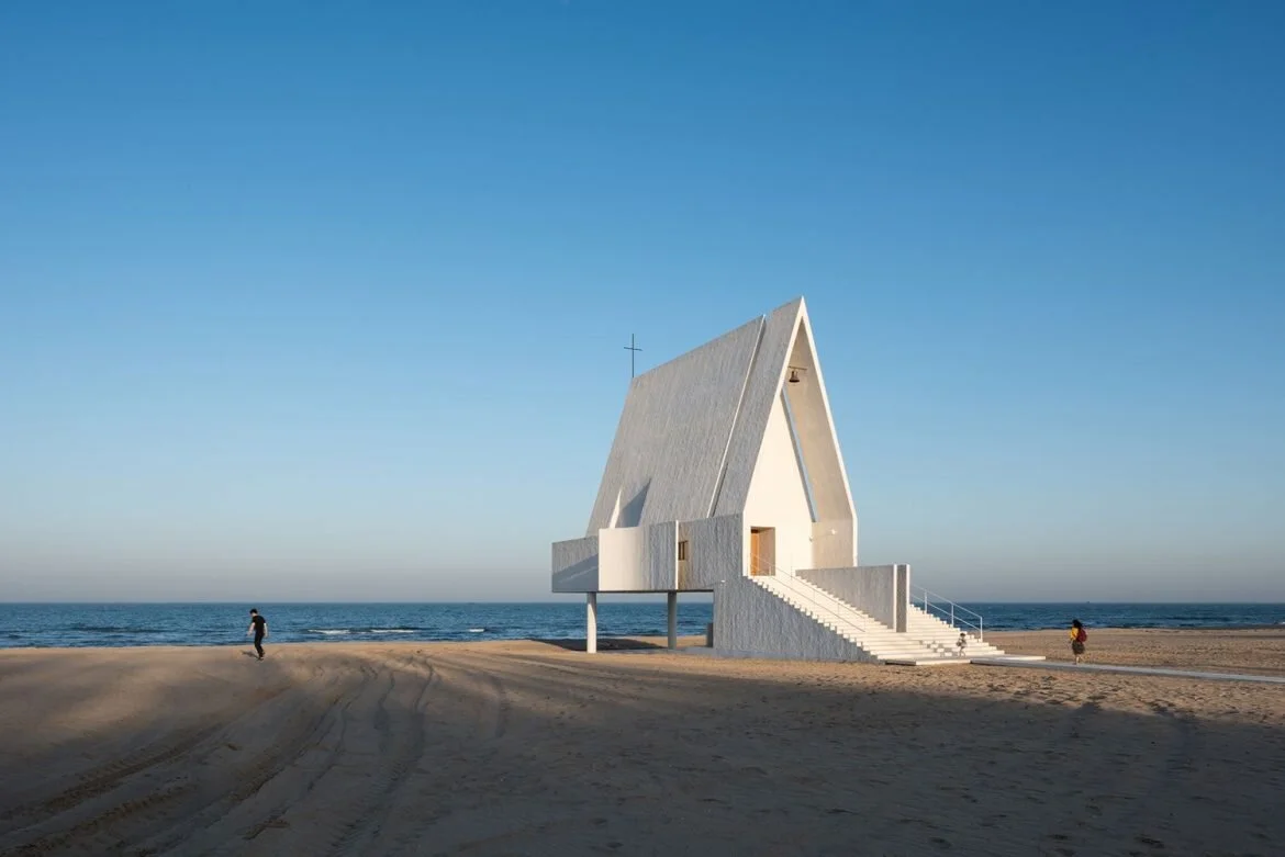 The Seashore Chapel by Vector Architects is raised up to seemingly drift upon high tide waters and transforms into a sheltered haven to rest during low tide. Natural light and ventilation flow through this timeless, serene structure.