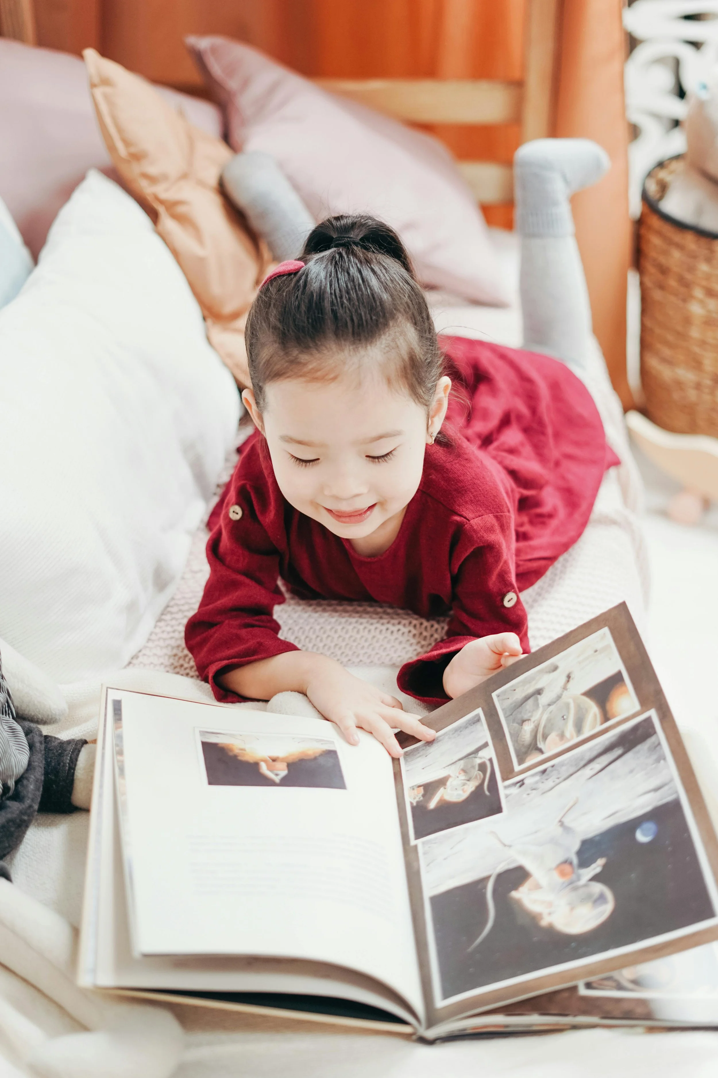 An early years learner developing lifelong literacy habits and independent task initiation through relaxed, screen-free reading