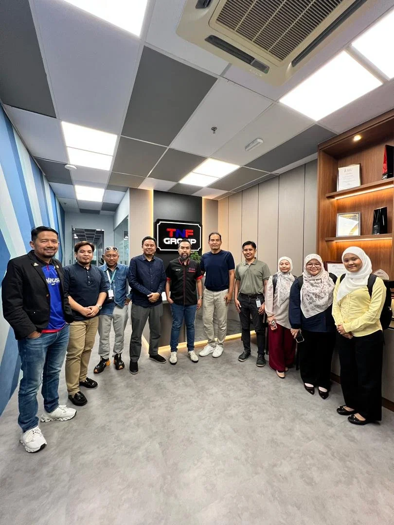 Group photo of UTM and ACTS representatives with the TNF Group team during a collaborative engagement at the TNF Group office.