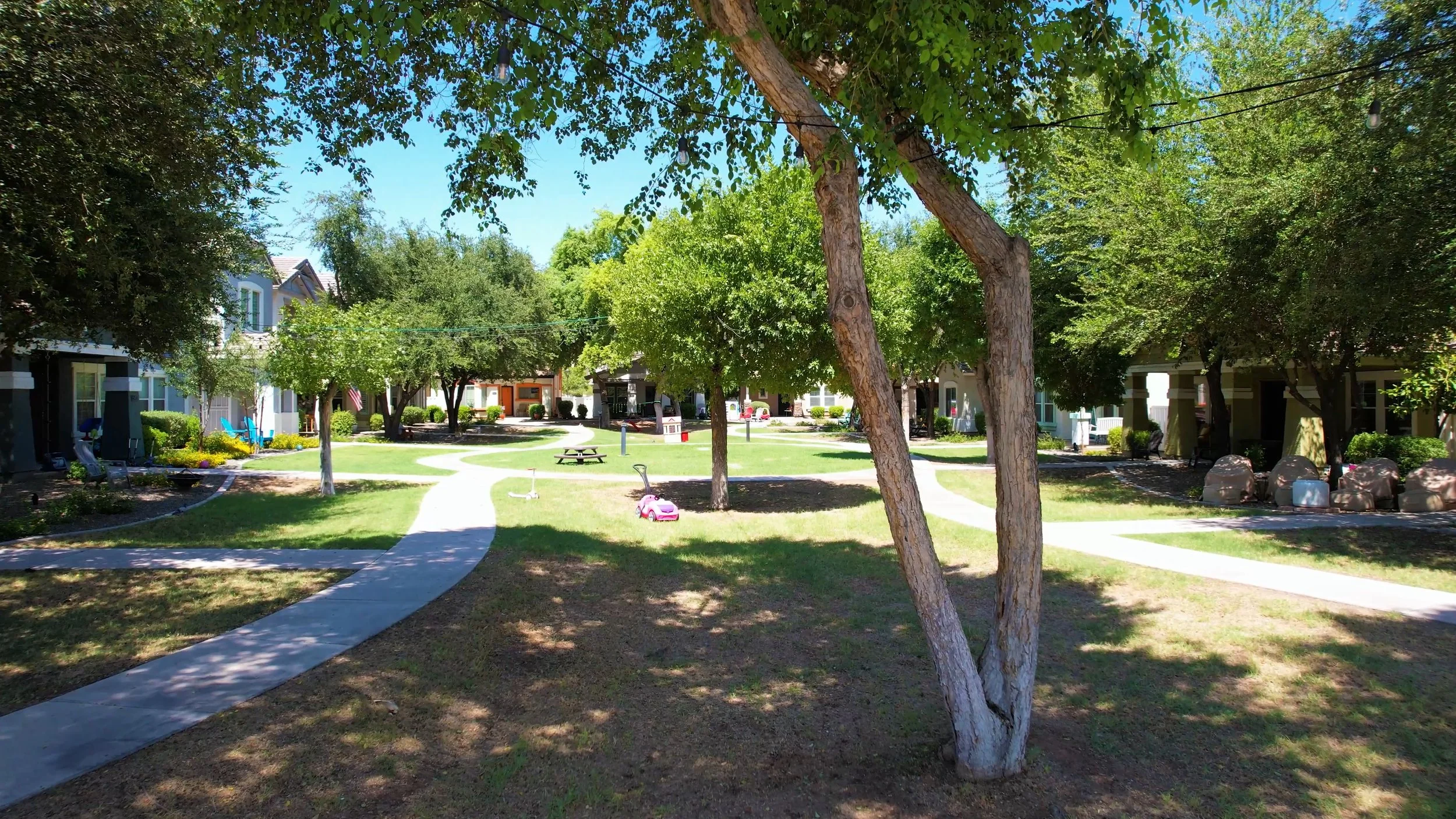Cottage homes with front porches around a shared green at Agritopia in Gilbert, Arizona