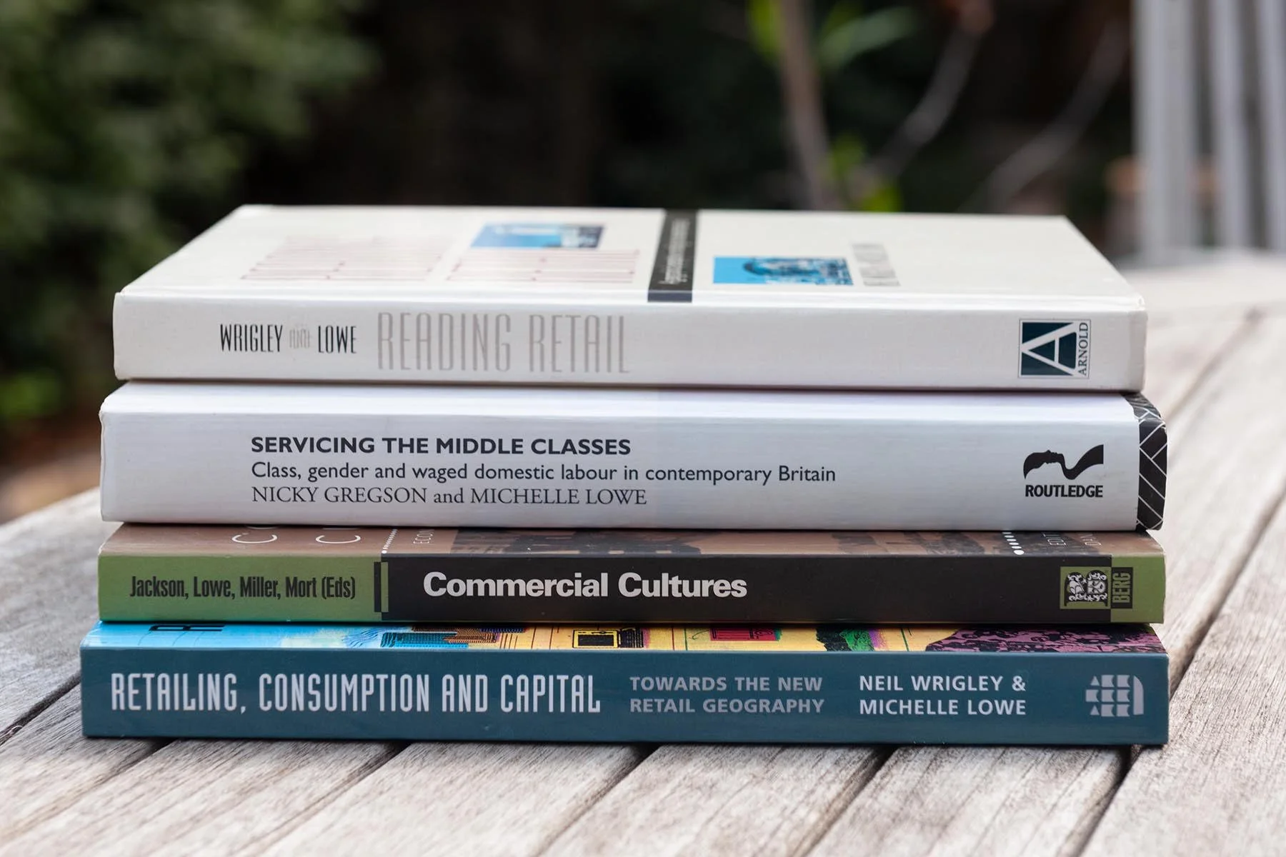 A stack of books co-authored by Dr Michelle Lowe on retail geography