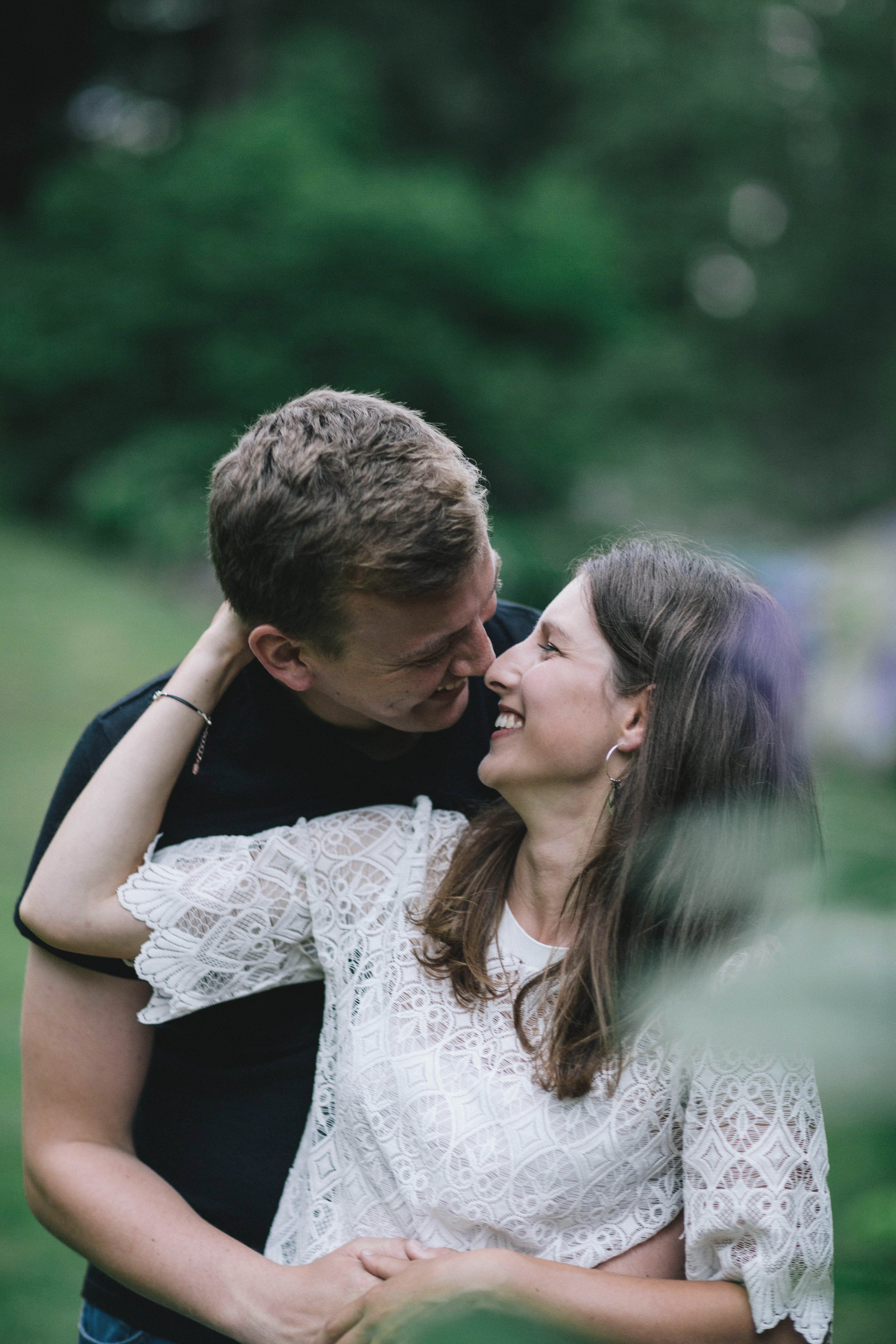 Couple smile at each other during their relaxed pre-wedding photography session