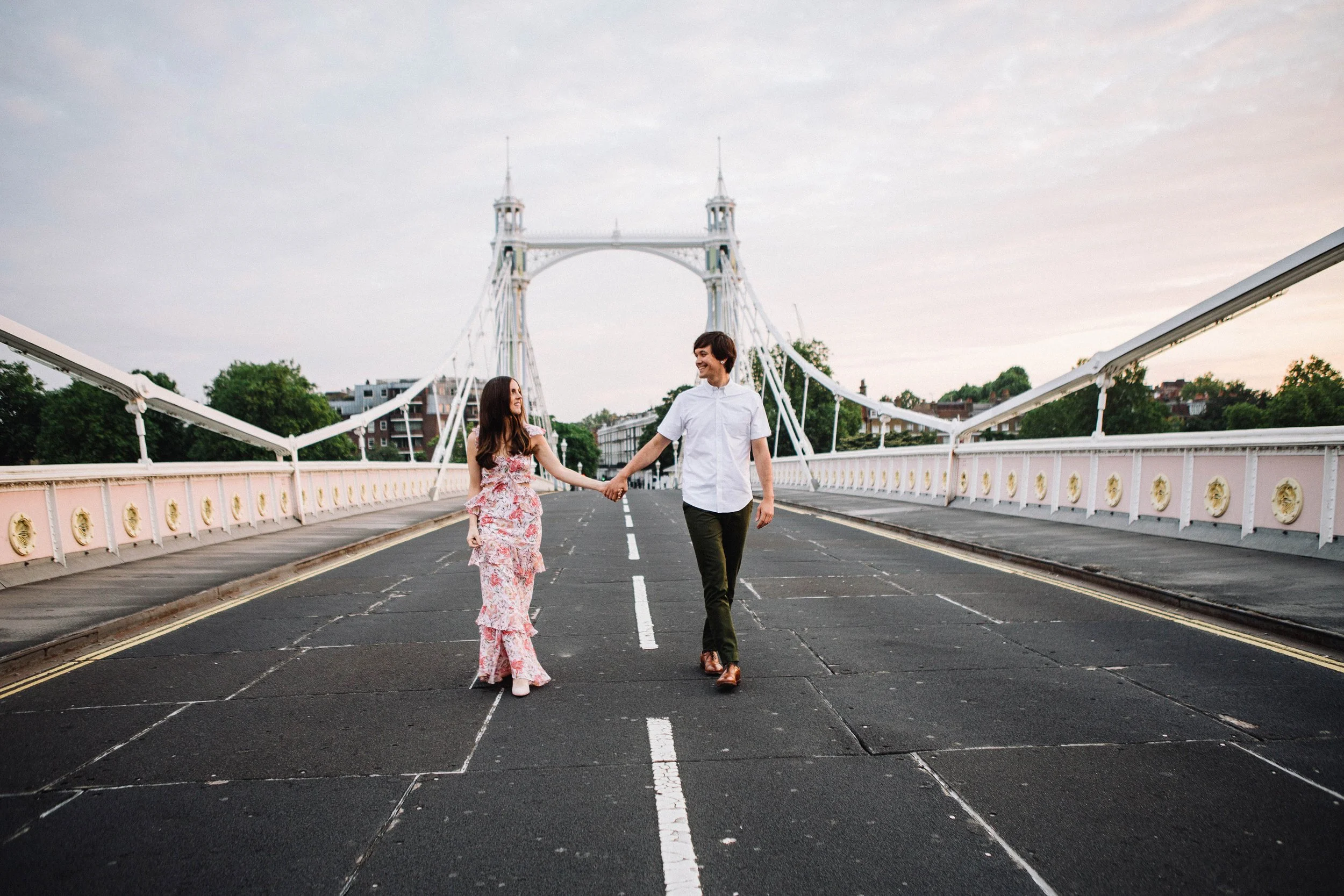 Couple walk hand in hand during their engagement photography session on Prince Albert Bridge