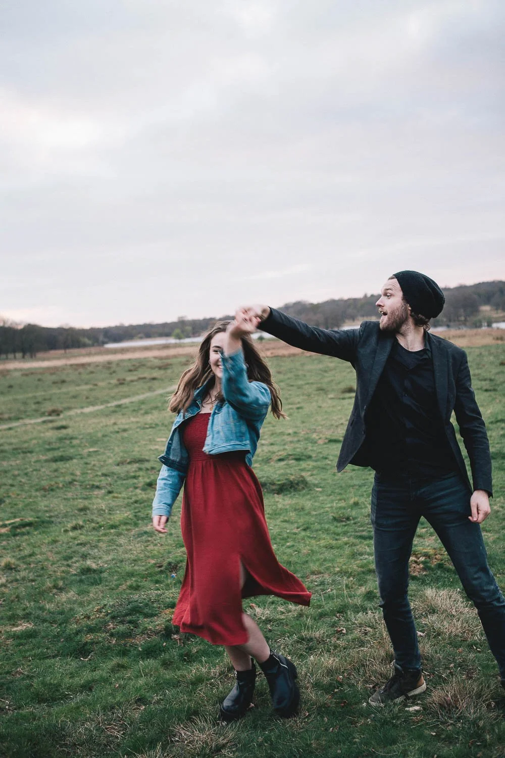 Couple dance during their pre-wedding photography session in Richmond Park