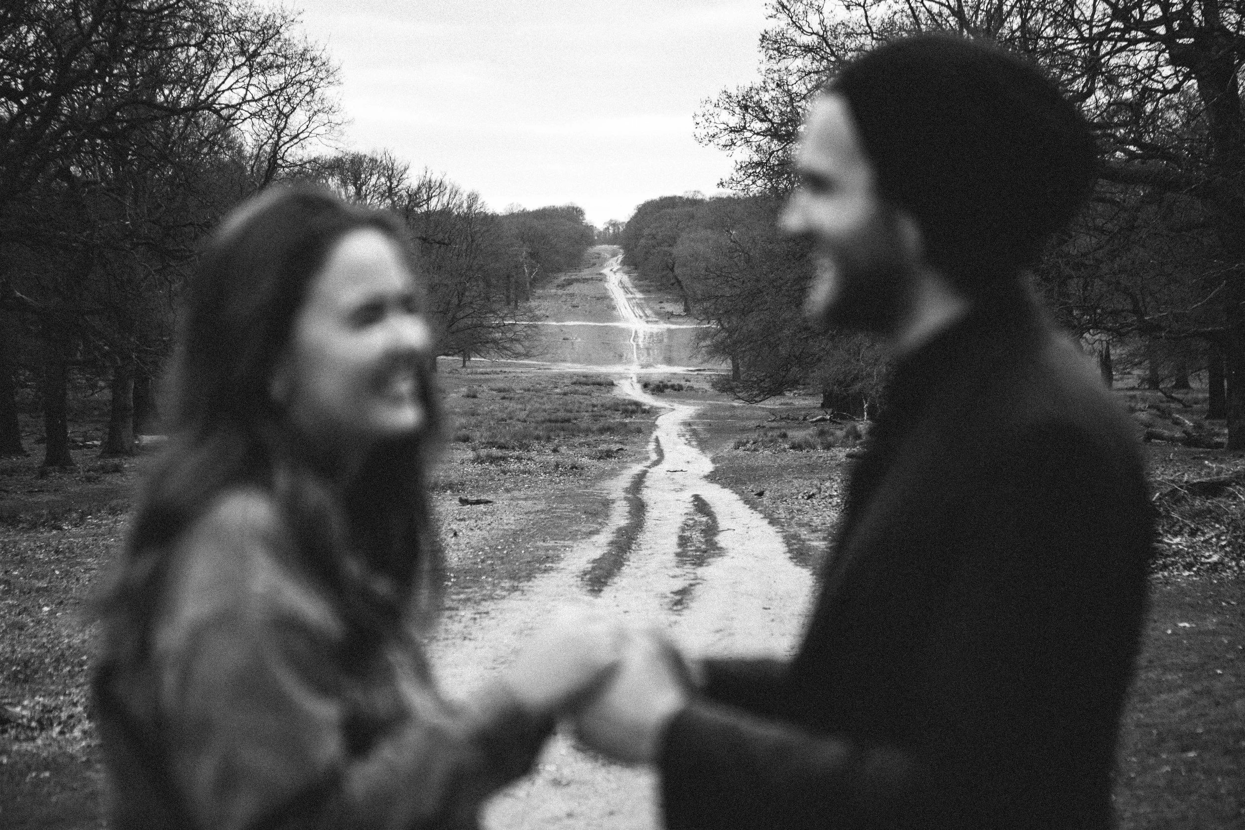 Couple blurred in the foreground with Richmond Park in the background during their engagement photography session.