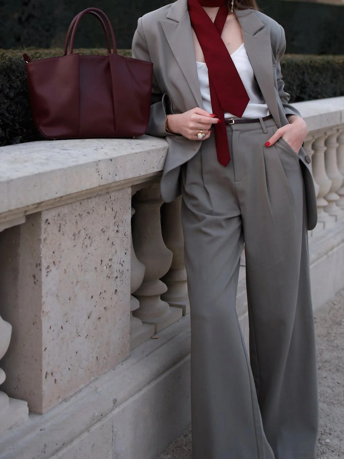 Burgundy KAAI leather bag & grey suit, Paris Fashion Week