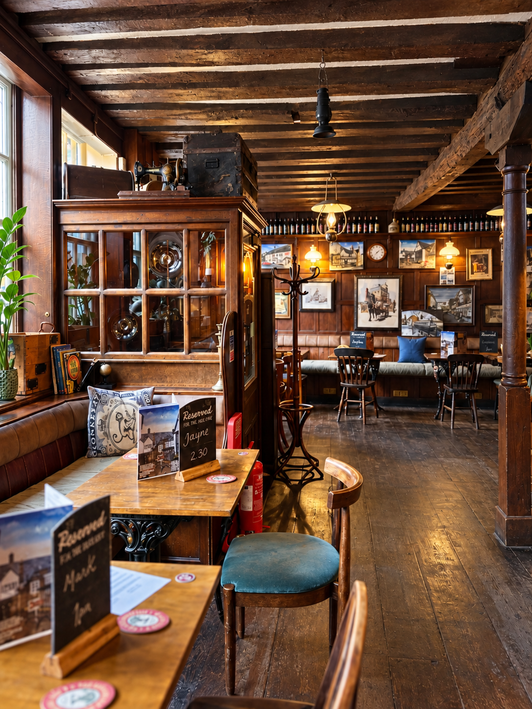 Traditional pub interior with exposed timber beams, wooden floors and upholstered seating.