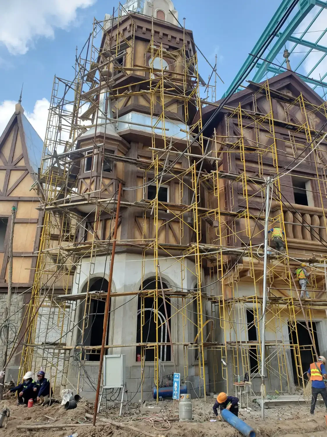 A large towered building surrounded by scaffolding