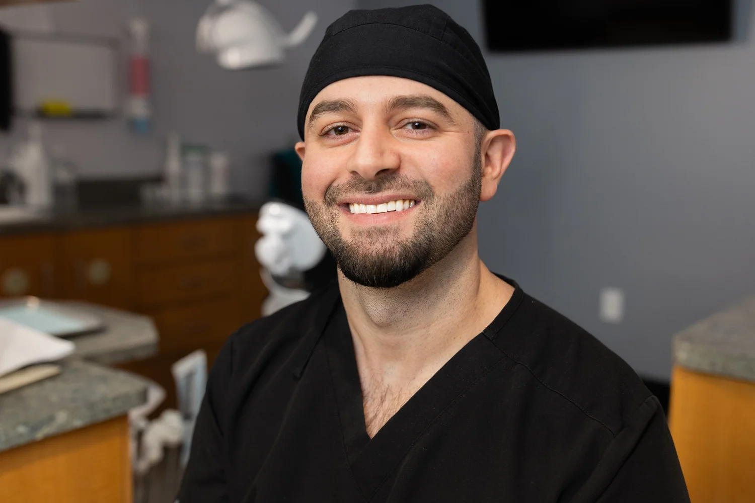 Dentist smiling in a treatment room