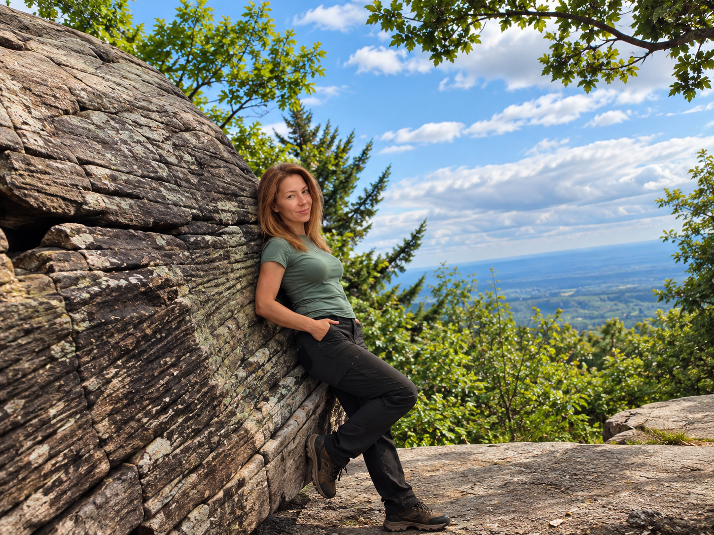 Image of a woman leaning on a rock