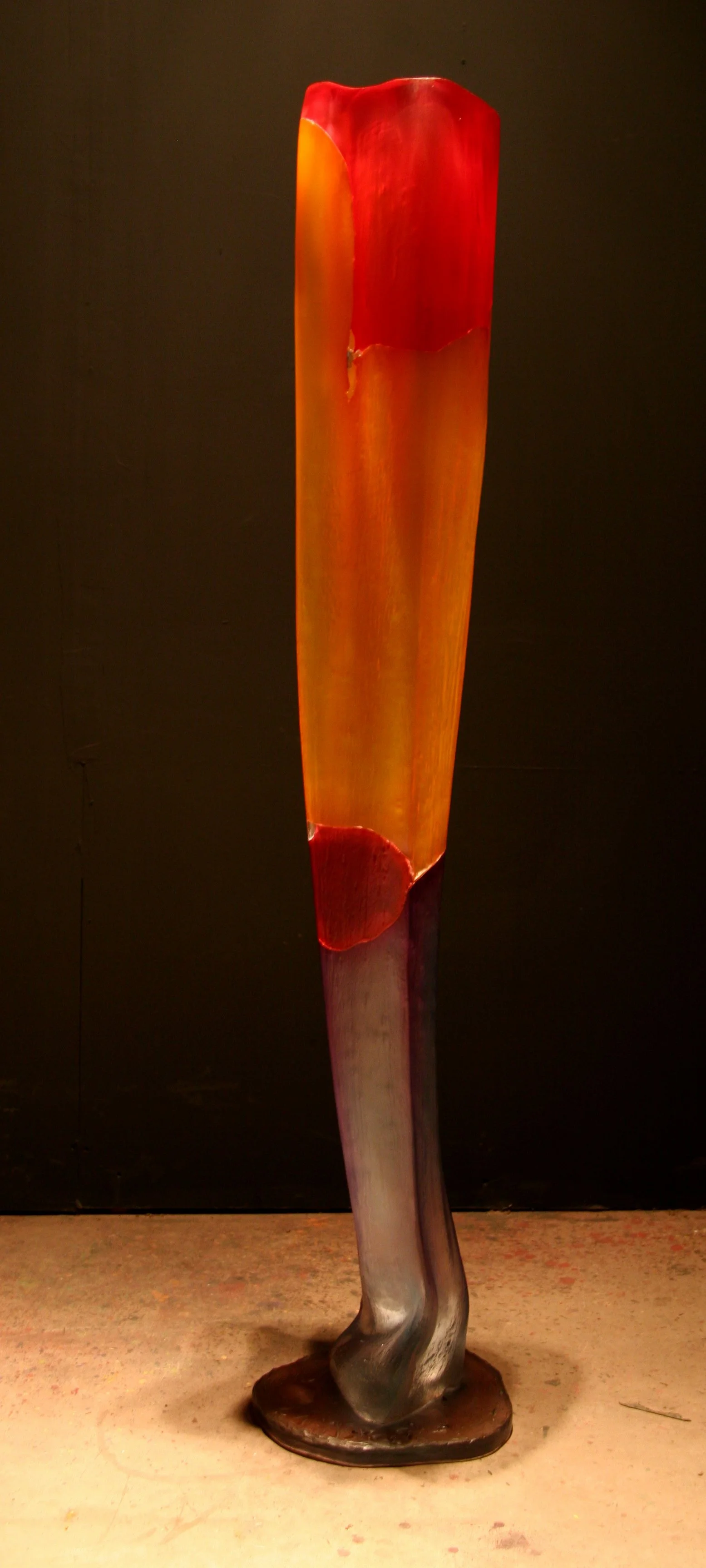 Desolation (2008) by Danny Perkins, a 69-inch oil on blown glass sculpture featuring a dark slate base and glowing amber-red glass body.