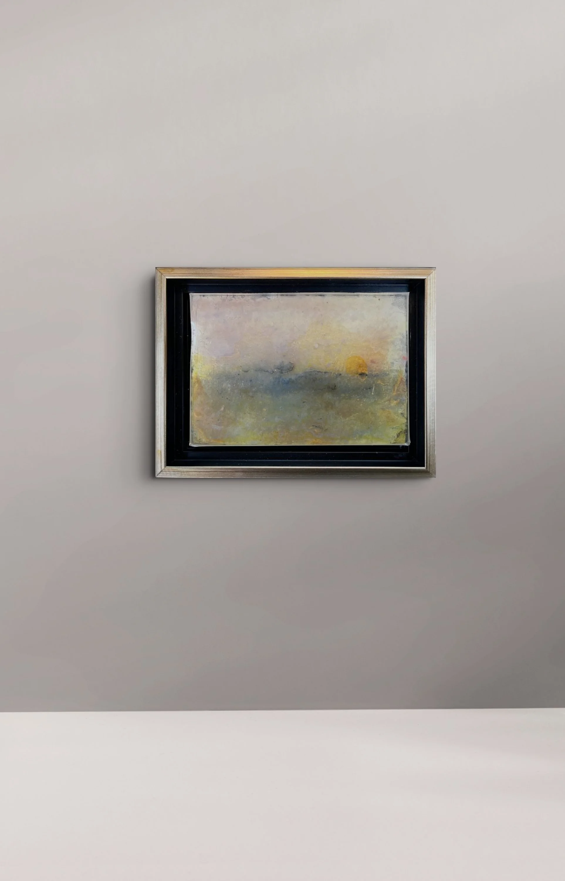 In situ view of No. 399 (Winter 2024) by Danny Perkins, a 6.5x8.5 inch oil on board with resin featuring a glowing sun-like sphere over misty grey-green color fields.