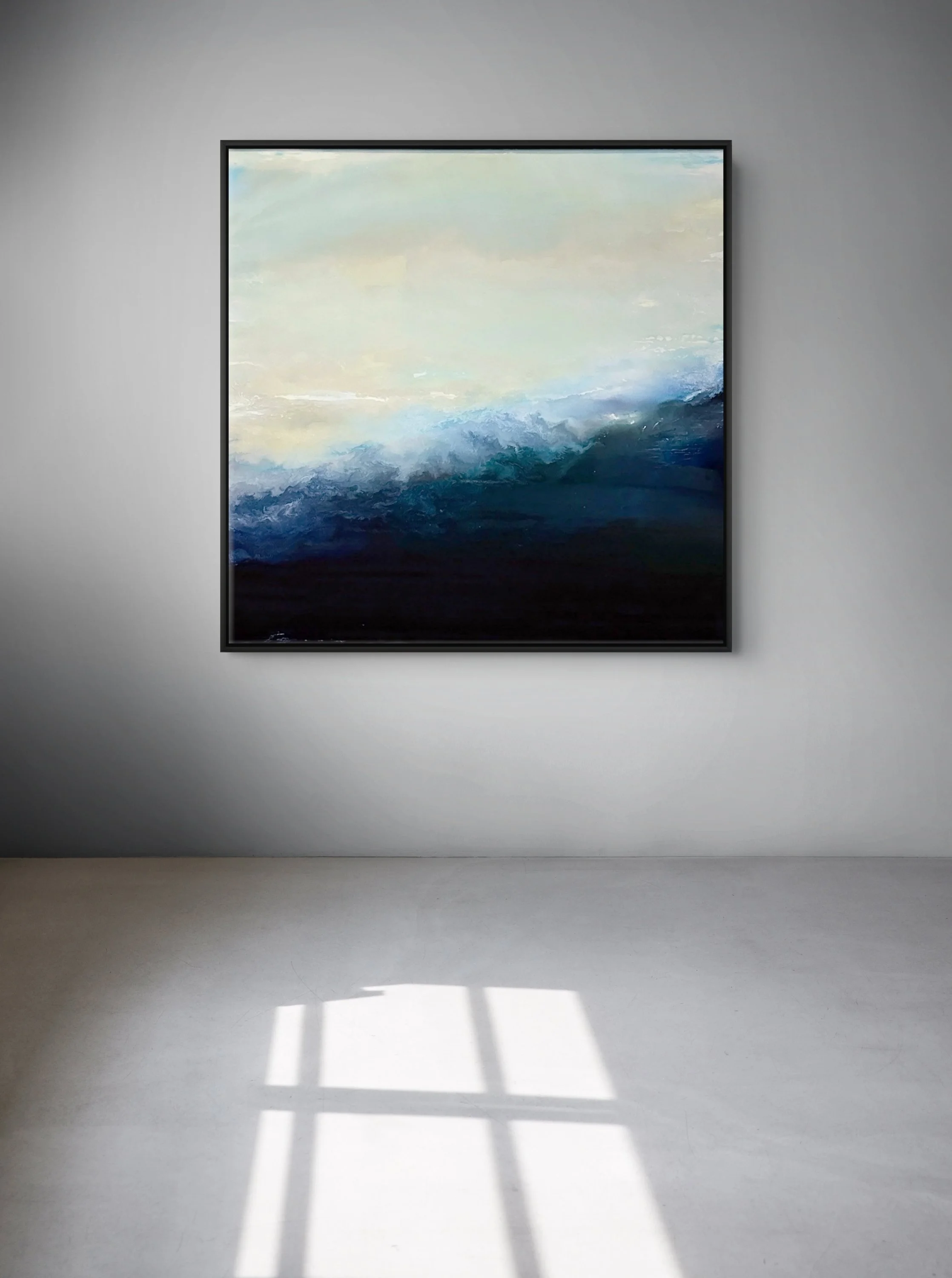 In situ installation view of No. 9 by Danny Perkins, a 46x46 inch oil and resin work featuring a dynamic, dark blue impasto wave against a pale yellow sky in a minimalist gallery setting.