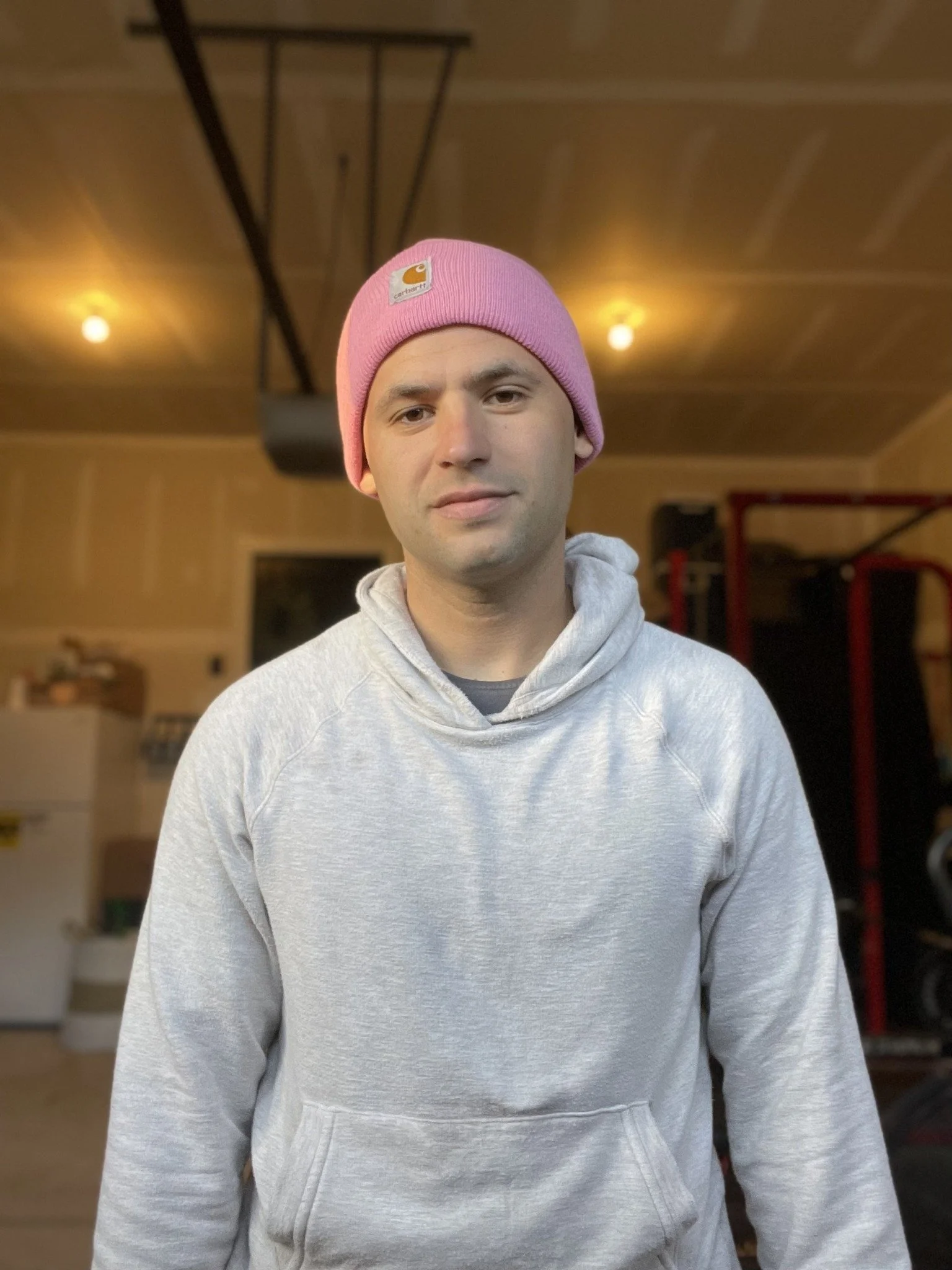 Josh Rulnick wearing a pink beanie and gray sweatshirt.