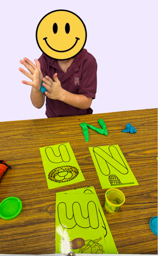 Student is reviewing N/M with play-dough.
