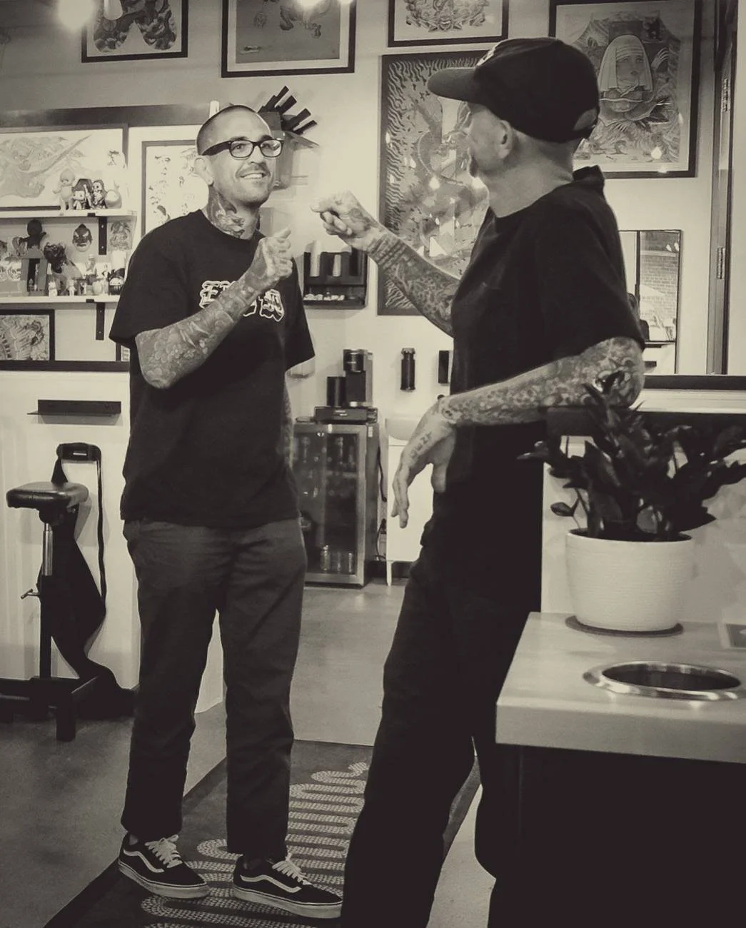 Two people talking in the shop, beside a station