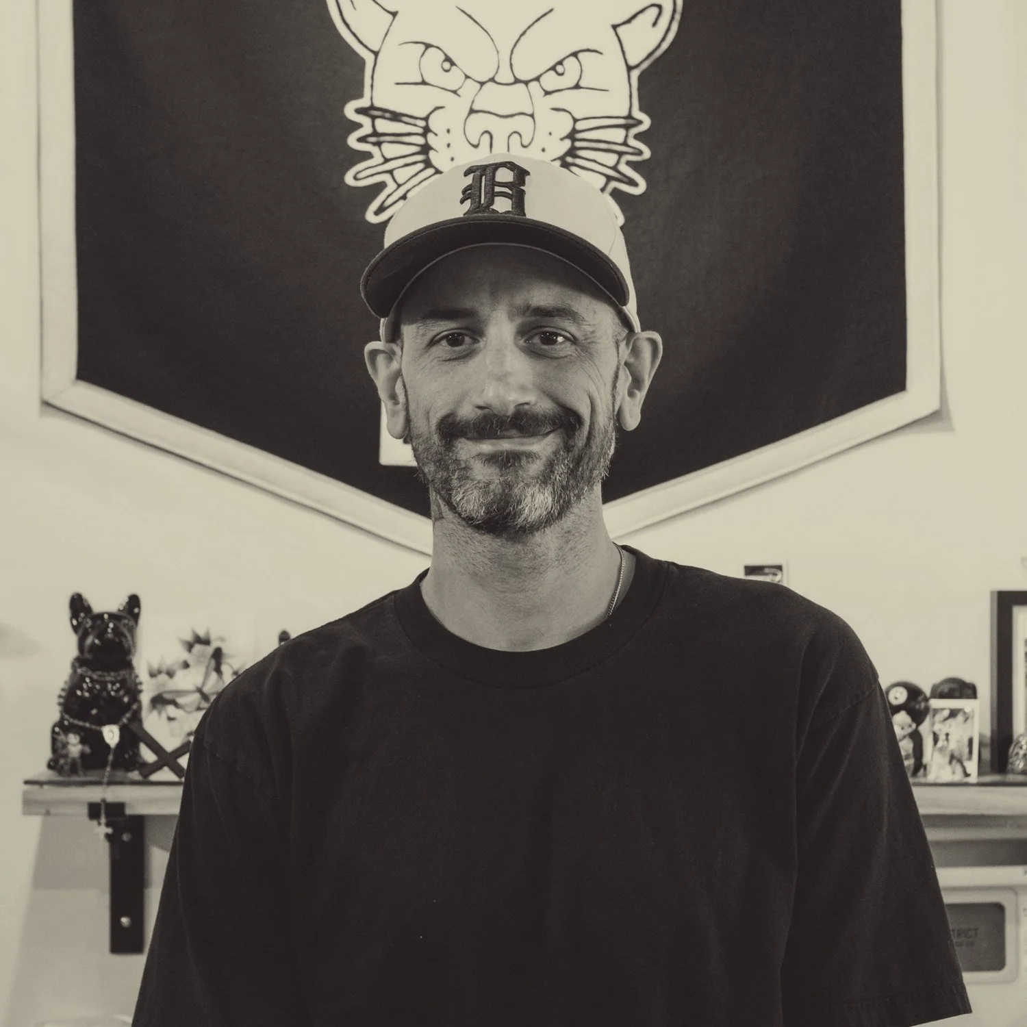 Billy Bennett in front of his pennant at the shop