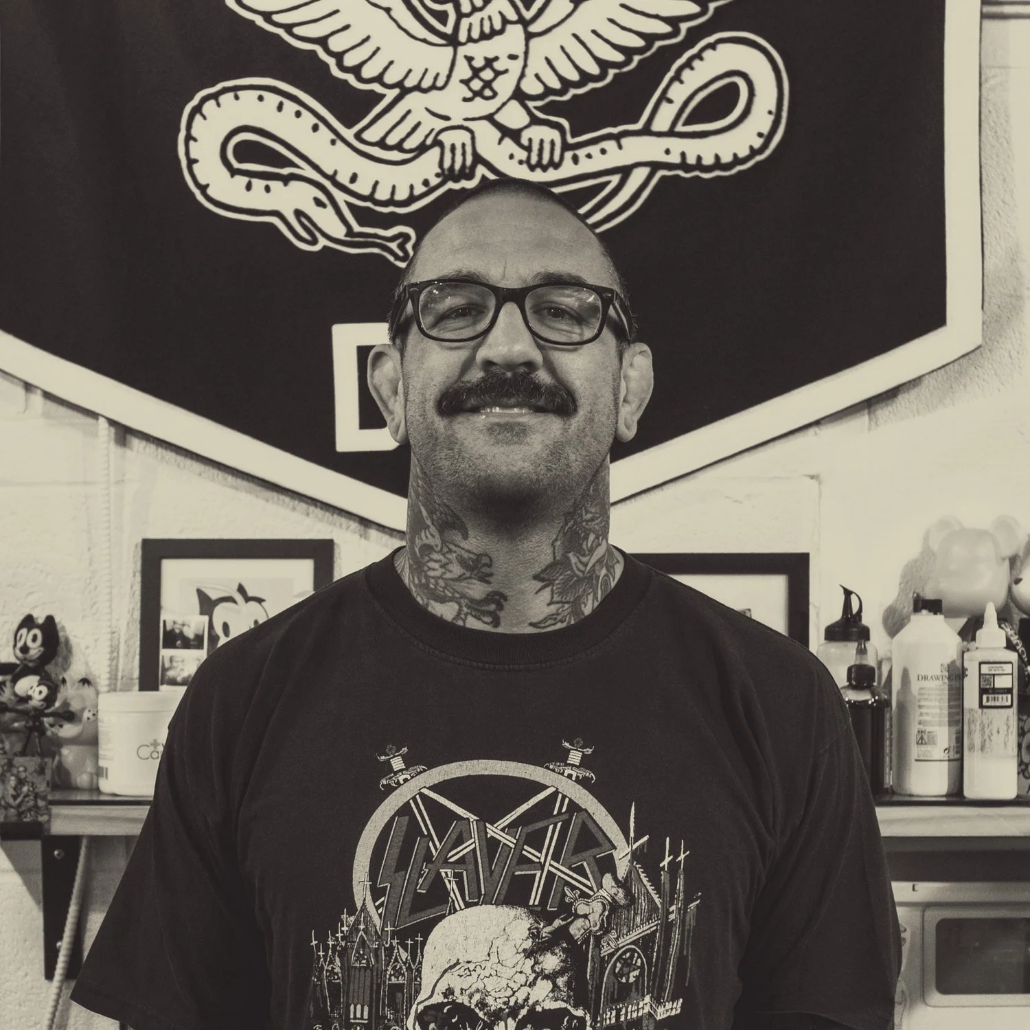 Ryan Clarke in front of his pennant at the shop