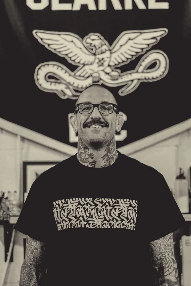 Ryan Clarke in front of his pennant at the shop