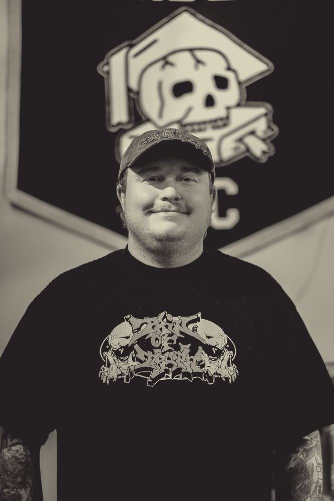 Nick Freidline in front of his pennant at the shop