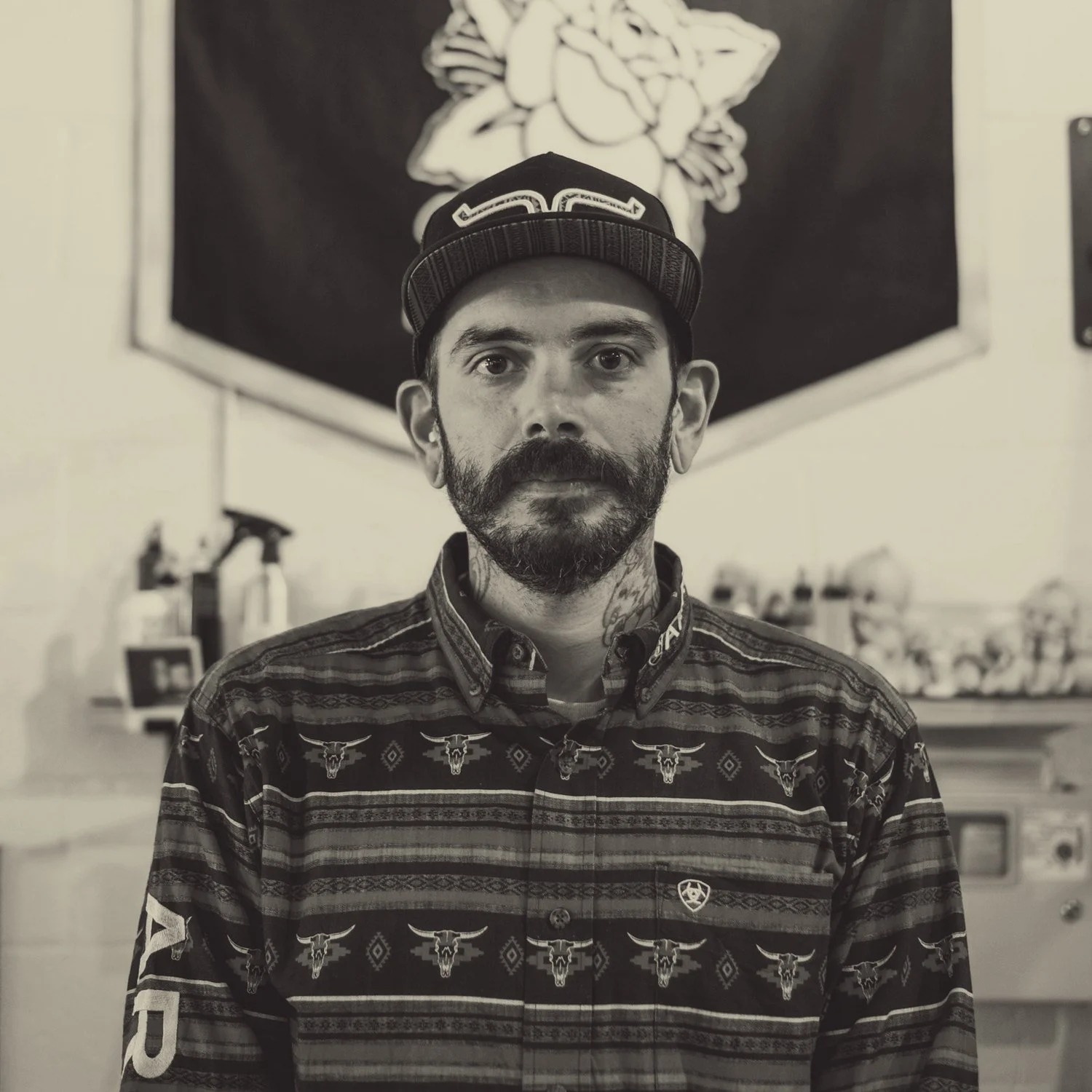 Drew Morgan in front of his pennant at the shop