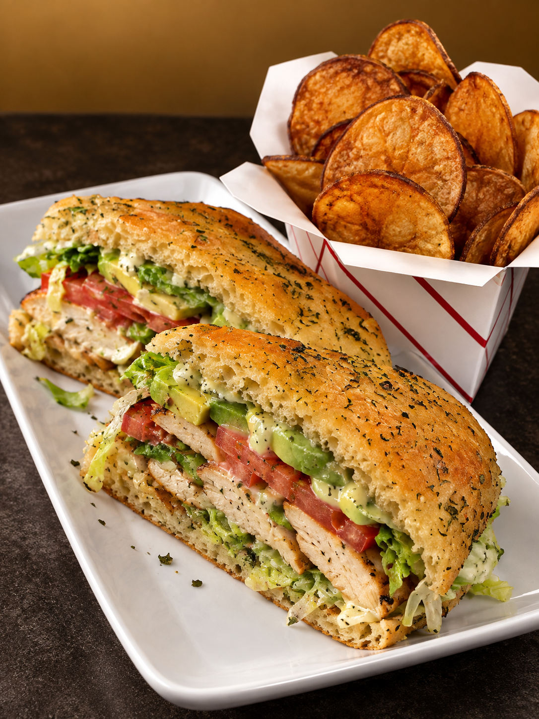 A club sandwich with grilled bread filled with chicken, bacon, lettuce, tomato, and avocado, served with a side of potato chips.