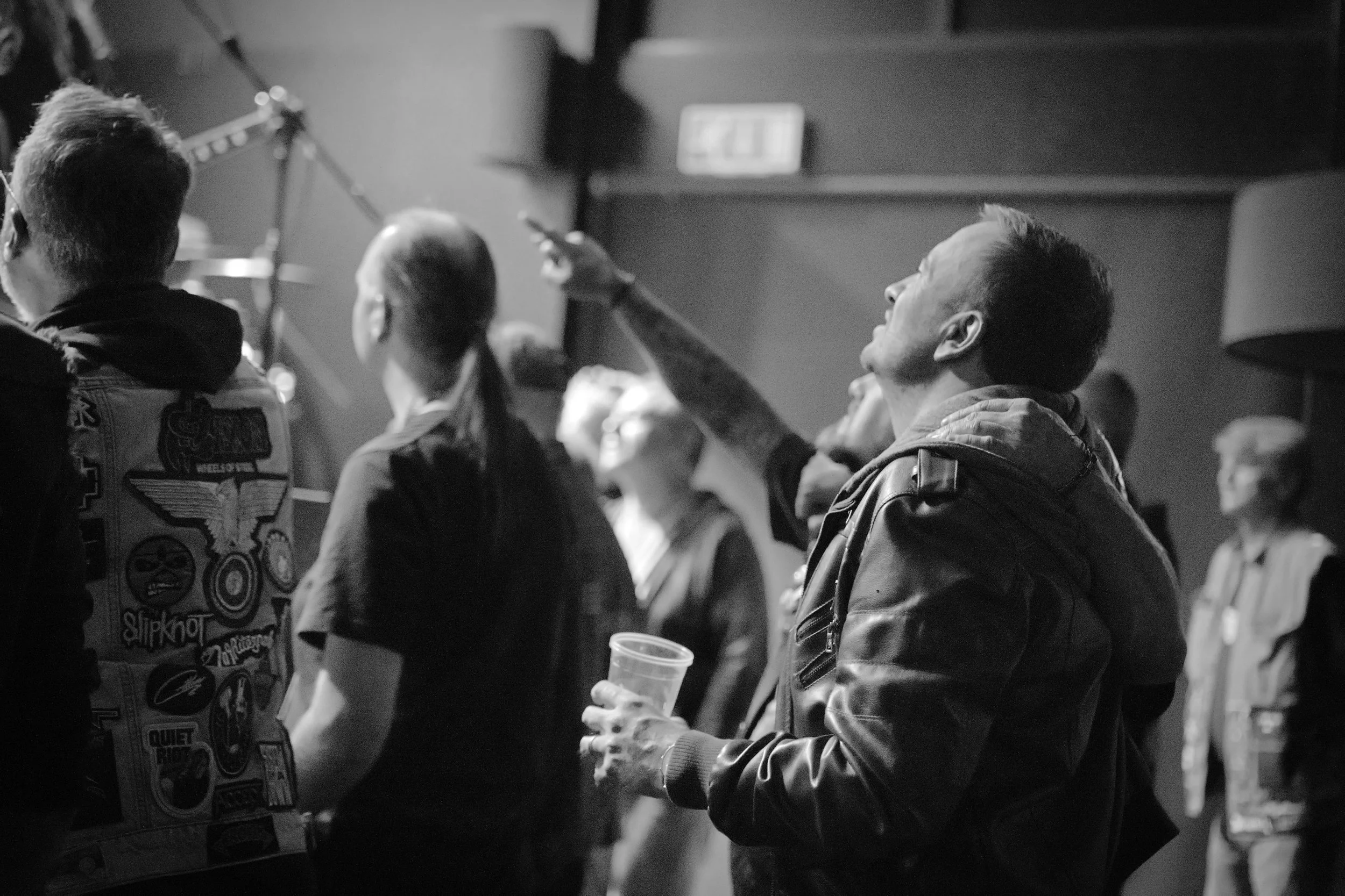 Black and white image of friends at a concert