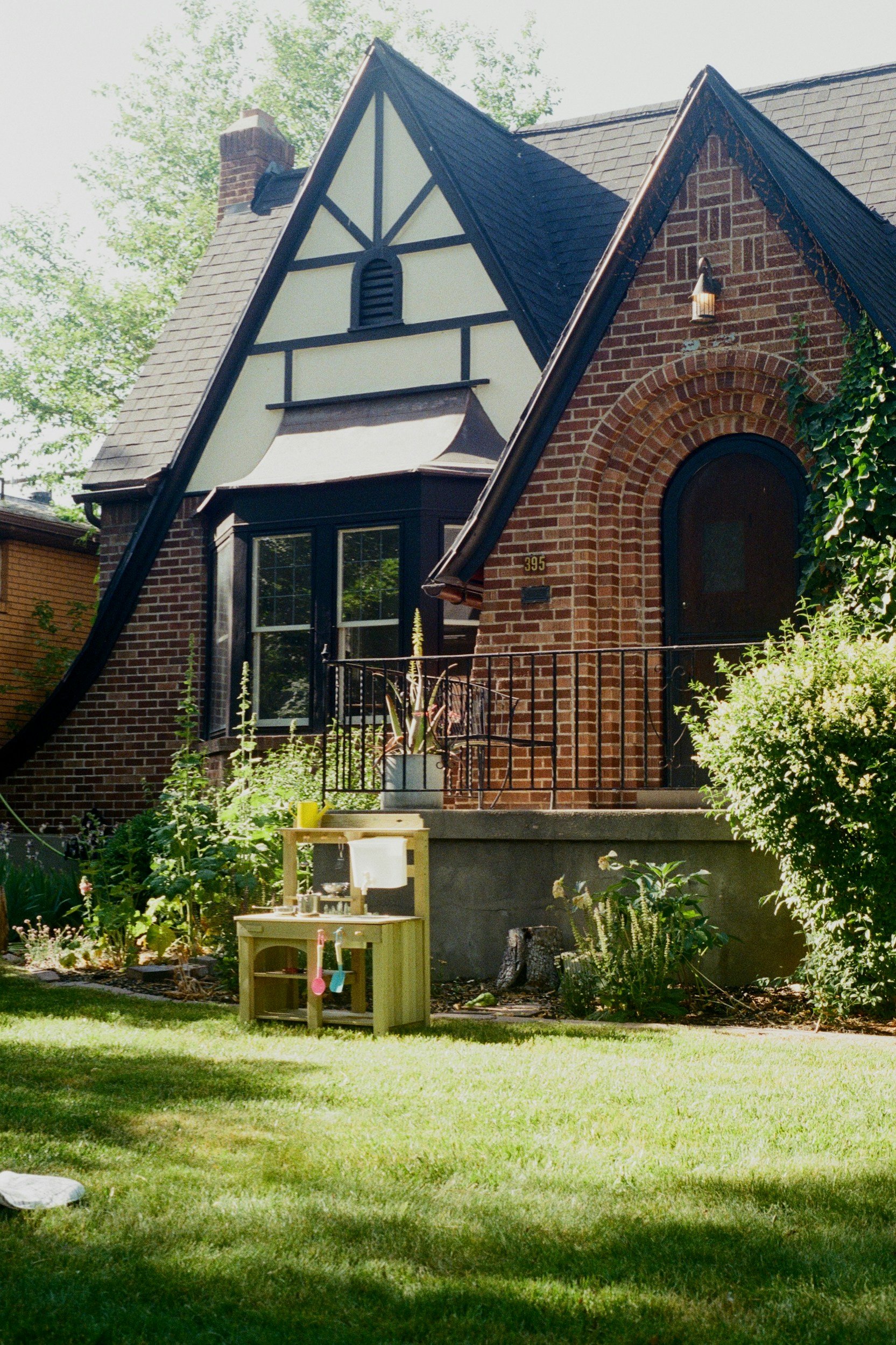 Brick Tudor-style home with a front lawn and garden, Platt Park neighborhood guide for Denver first-time home buyers