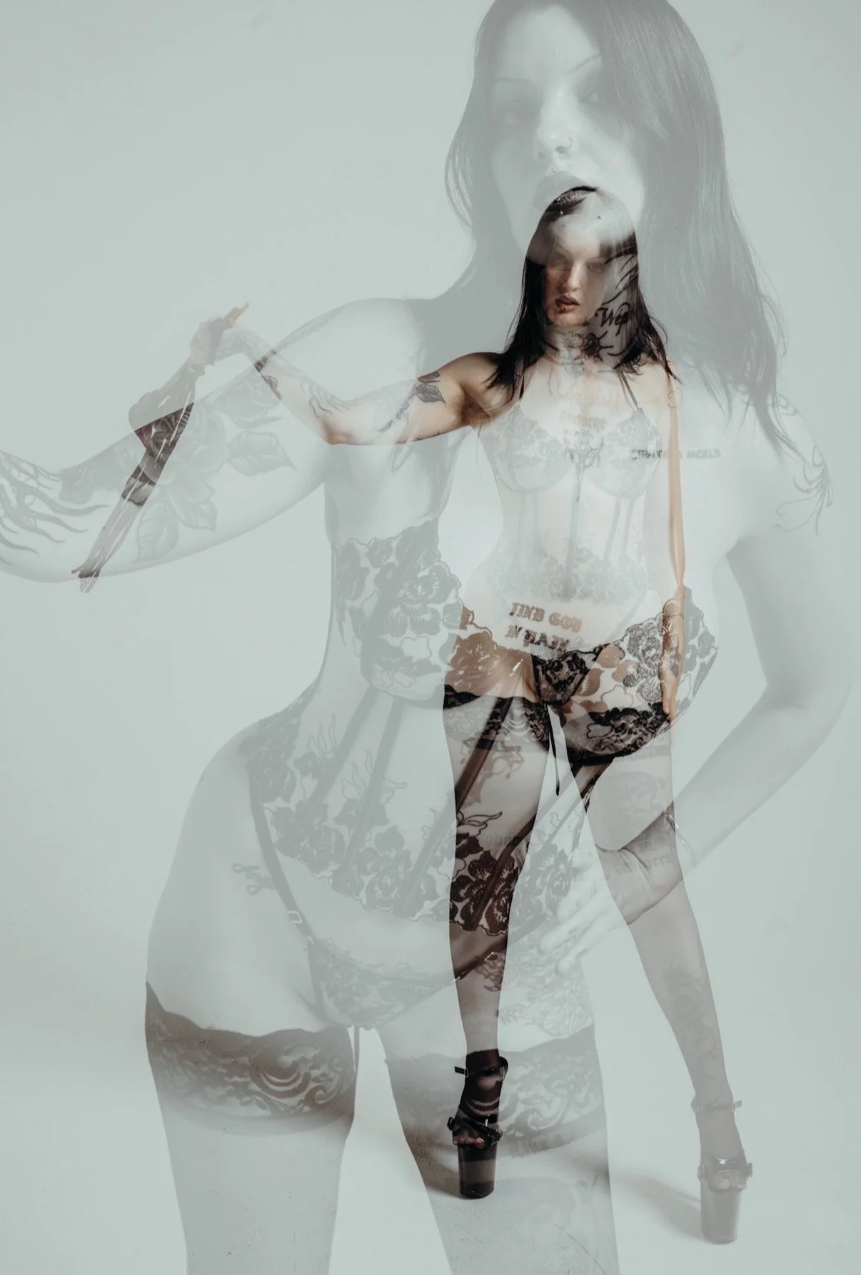 Multiple overlapping images of a woman with tattoos, dark hair, and wearing lingerie and high heels. Goddess Angelica Addams.