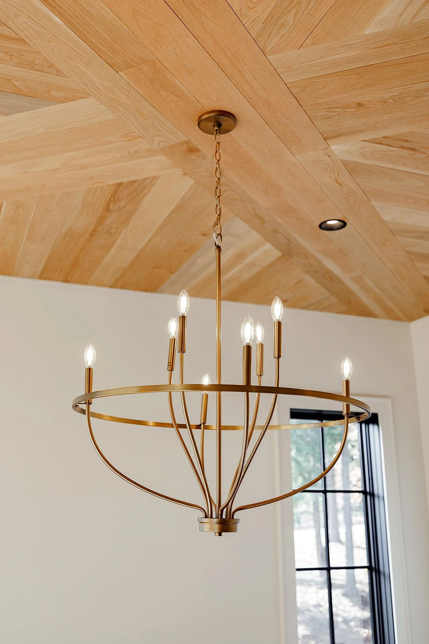 Chevron wood ceiling with brass chandelier