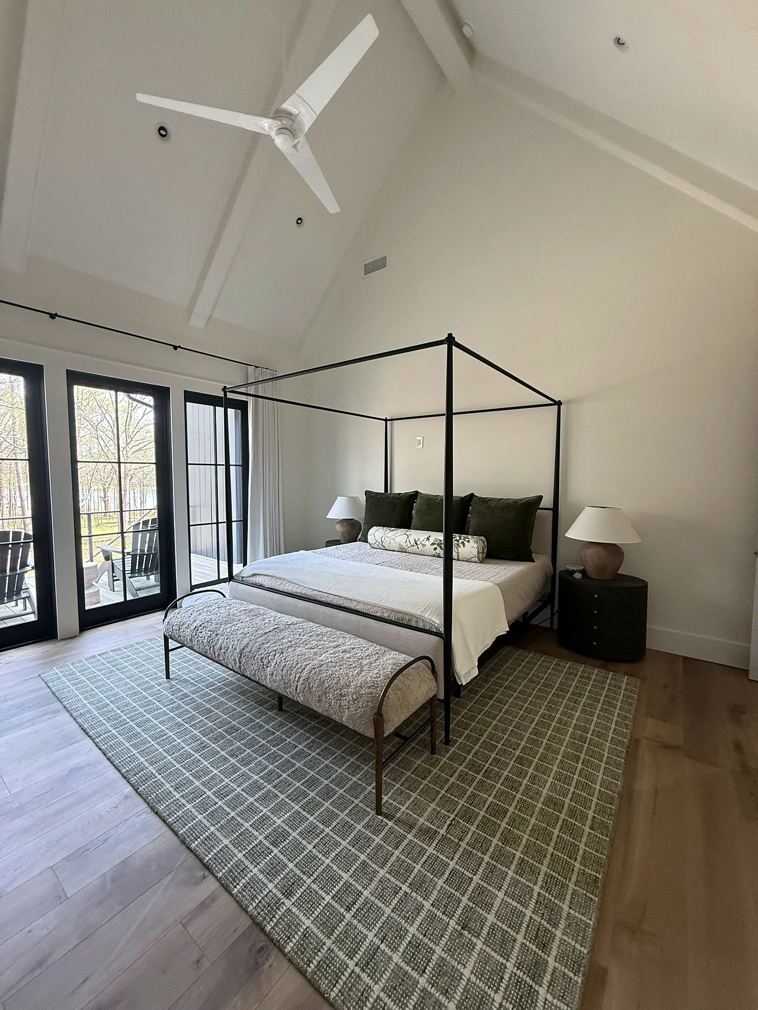 Furnished primary bedroom with vaulted ceiling and canopy bed