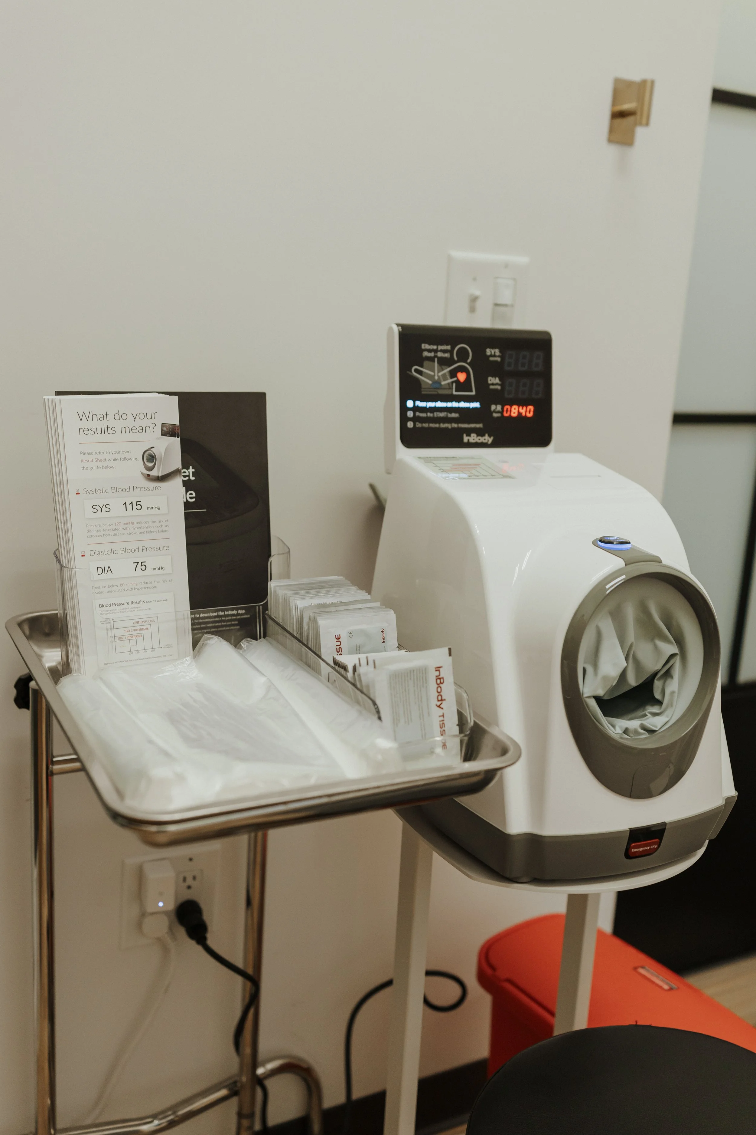 InBody body composition analyzer with blood pressure monitor and results guide in a clinical examination room