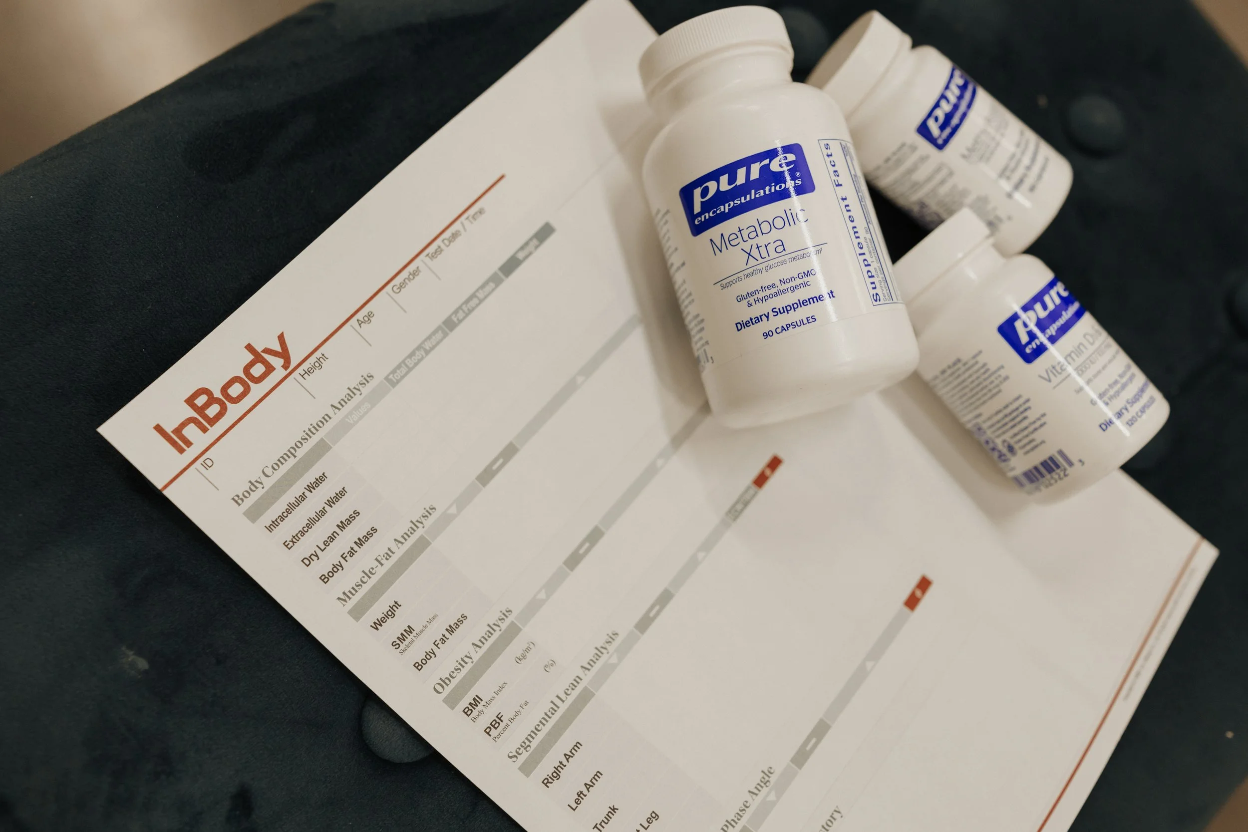 Pune dietary supplement bottles and a body composition analysis report