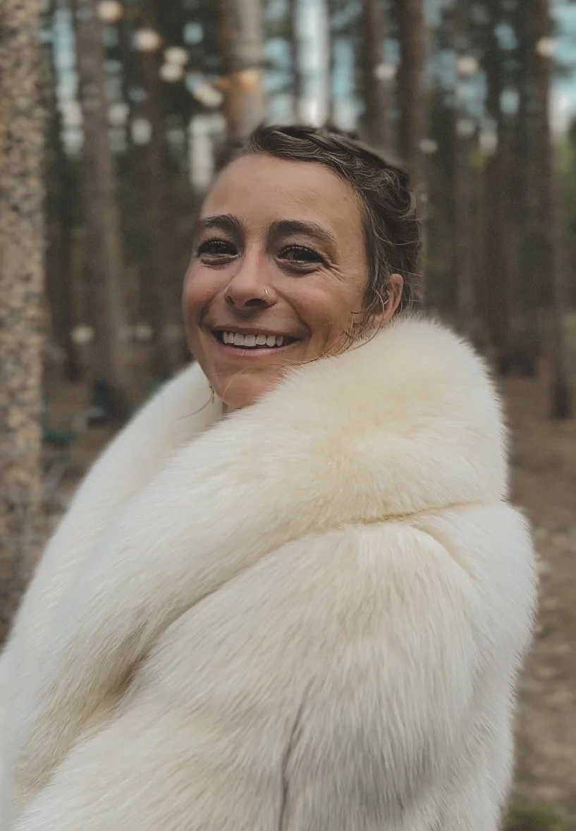 Kaylee, the creative soul behind Intution earrings on her wedding day wearing a white fur coat.