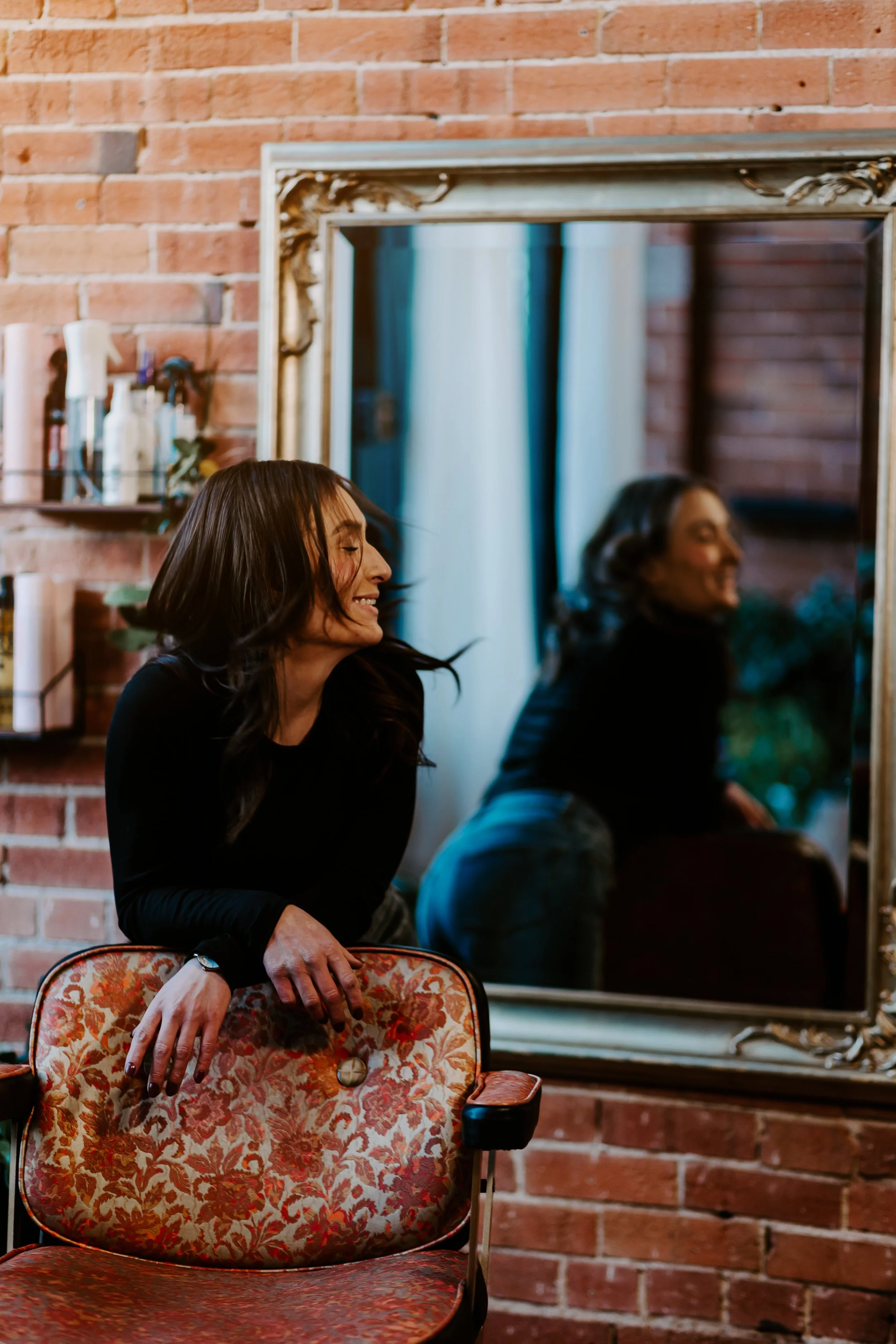 Alyssa, the creative soul behind Rootbound, an Art Salon with her thrifted vintage salon chair.