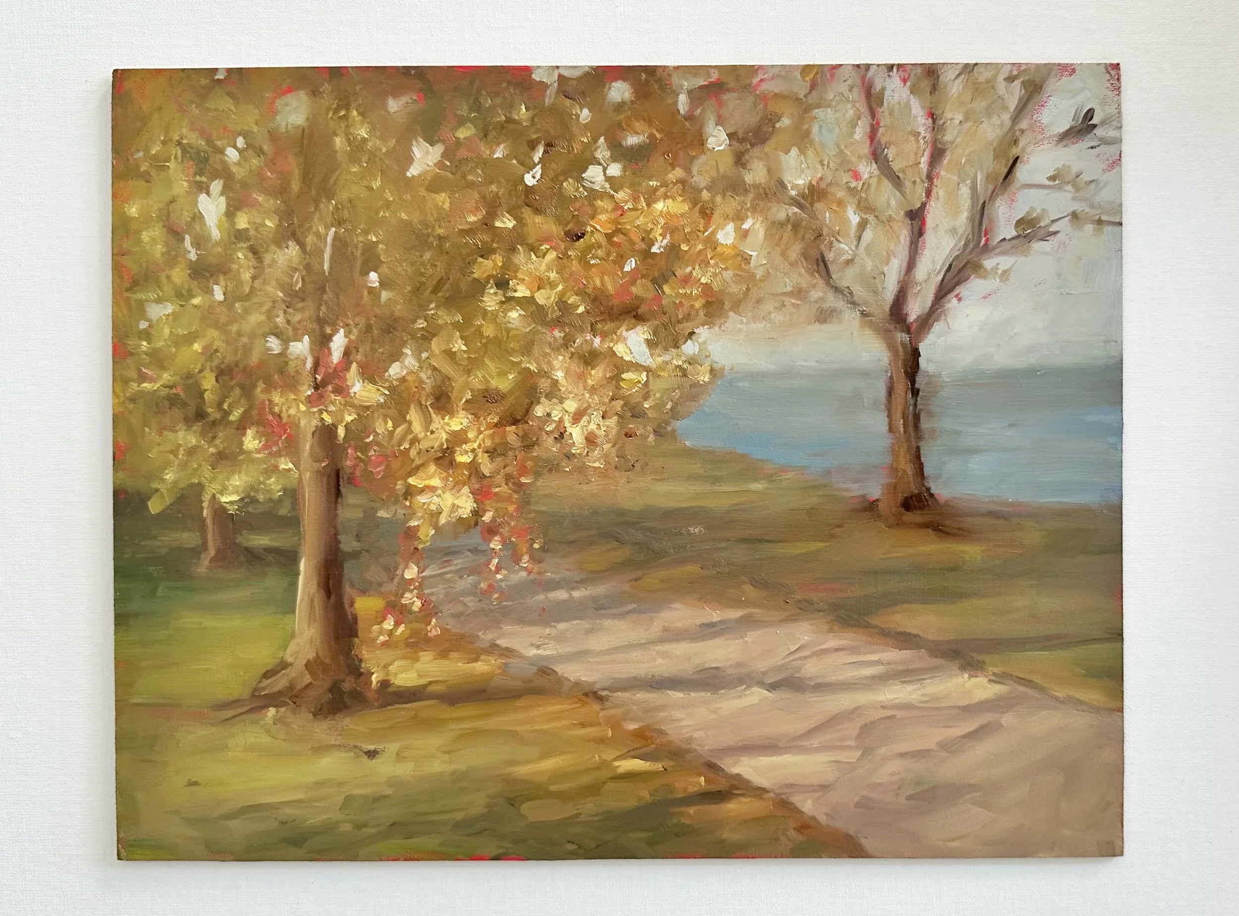 Impressionist oil painting of a tree-lined path beside a calm blue lake in autumn.