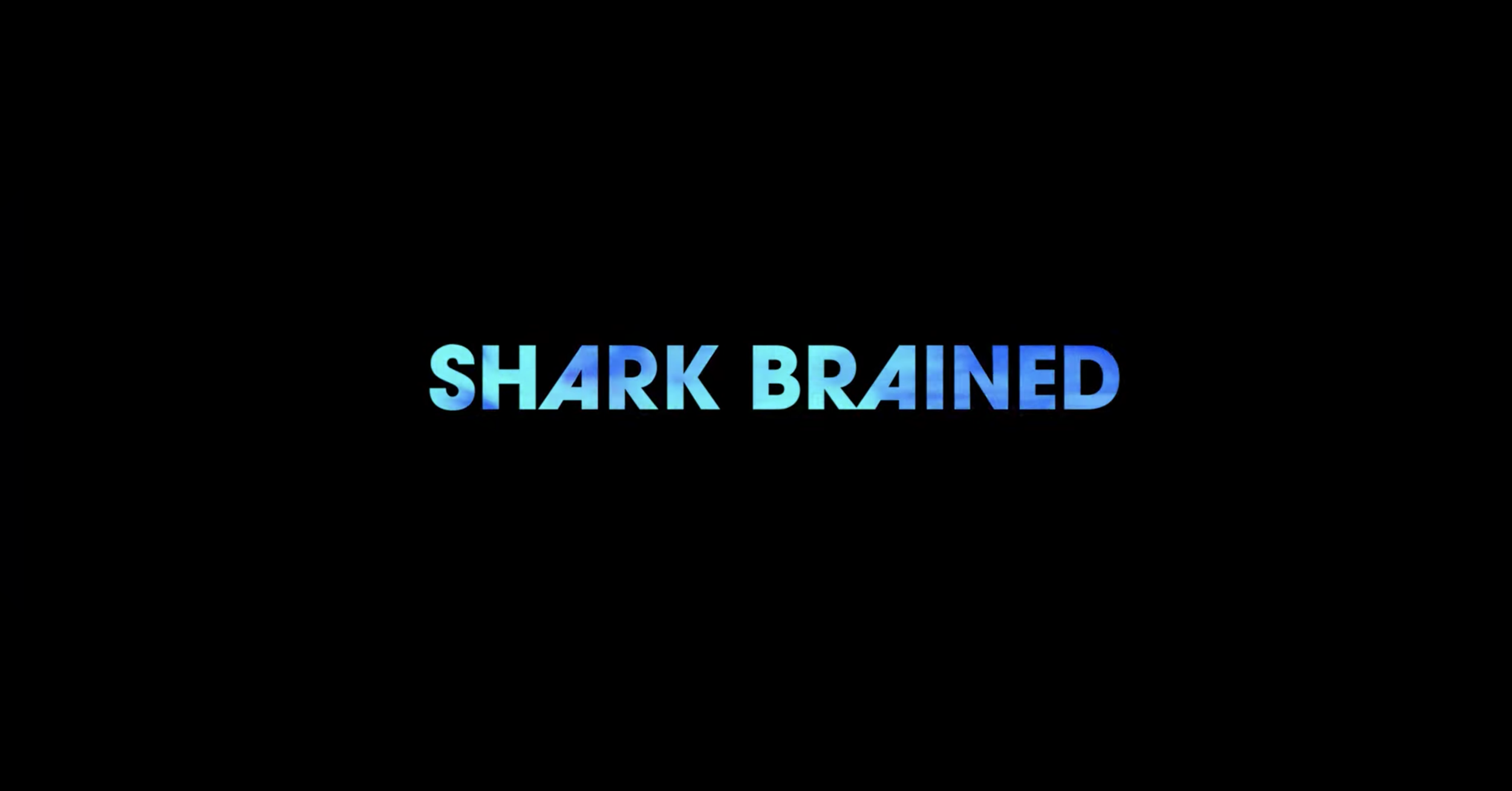Title screen with the words 'Shark Brained' in blue gradient text on a black background.